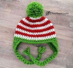 a green and red striped knitted hat with pom - pom on top