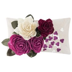 purple and white flowers are on the back of a pillow with sequins around it