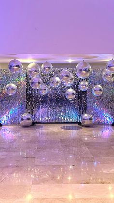 a room filled with shiny disco balls on the wall and floor next to each other