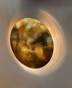 a close up of a gold colored object on a wall