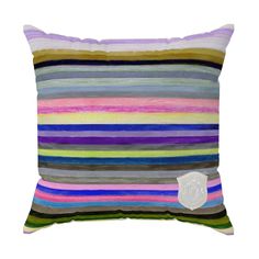 a multicolored striped pillow with a white patch on the front and back side