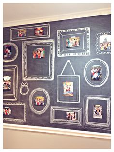 a chalkboard with pictures on it in front of a wall that has multiple frames