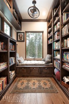 a room with many bookshelves and a rug on the floor