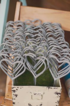 a box filled with lots of metal hearts