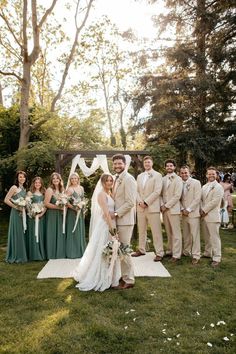 a group of people standing on top of a lush green field next to each other