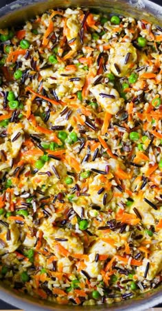 a pot filled with rice and vegetables on top of a stove