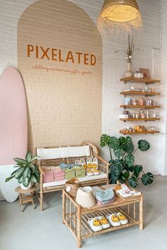 a room filled with lots of furniture next to a brick wall and potted plants