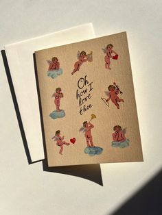 two greeting cards with cupid angels and the words oh, how love this one?