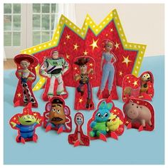 the toy story characters are on display in front of a star shaped card and other toys