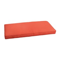 an orange outdoor bench cushion on a white background