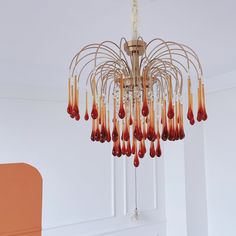 a chandelier hanging from the ceiling in a room with white walls and flooring