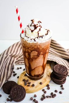 a chocolate milkshake with whipped cream and oreo cookies