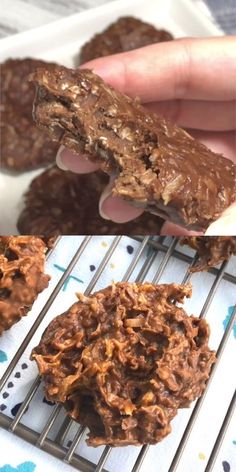 chocolate cookies are cooling on a rack and being held up by someone's hand