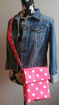 a pink polka dot purse sitting on top of a mannequin