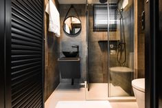 a bathroom with a toilet, sink and shower stall in the middle of it's walls