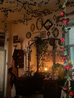 a room filled with lots of flowers and pictures on the wall next to a dresser