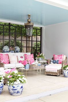 a living room filled with lots of furniture and flowers