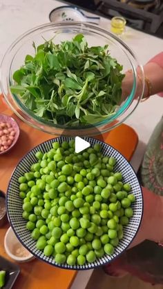 a person holding a bowl full of green peas and sprouts in front of other bowls