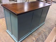 a large wooden counter top sitting on top of a hard wood floor