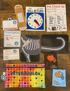 an assortment of dog related items are displayed on a table with tags and magnets