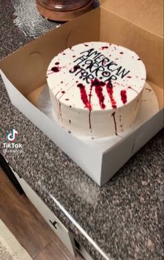 a birthday cake with white frosting and red sprinkles on it in a box