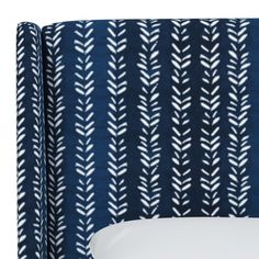 an upholstered headboard with blue and white fabric