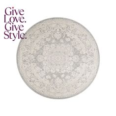 a round rug with an ornate design on the top and bottom, in grey tones