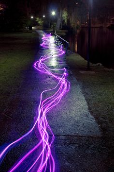 long exposure photograph of purple lights on the sidewalk