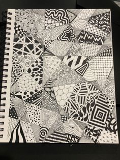 a notebook with black and white designs on it