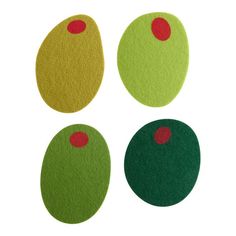 four green and yellow circles with red dots on them, all in different sizes or shapes