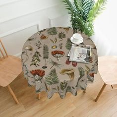 an elephant print table cloth on top of a wooden chair next to a potted plant