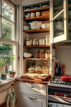 a kitchen filled with lots of dishes and cooking utensils on top of wooden shelves