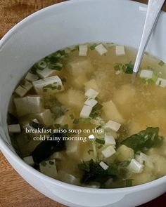 a white bowl filled with soup on top of a wooden table