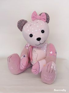 a pink teddy bear with polka dots on it