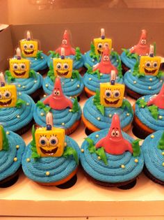 some cupcakes with blue frosting and yellow decorations