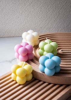 small candles are on a wooden tray