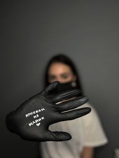 a woman wearing black gloves with white writing on her hands and the words mmmmmama mamma written on it