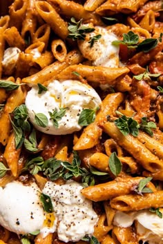 pasta with sauce, cheese and herbs in a bowl