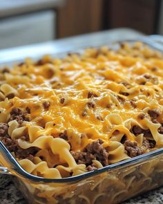 a casserole dish with cheese and ground beef