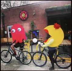 two people on bikes with fake faces in the shape of chickens and roosters for halloween