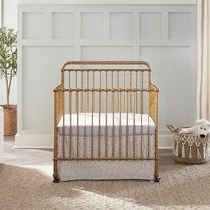 a baby crib in the corner of a room with white walls and beige carpet