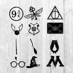 some harry potter symbols on a white wooden background