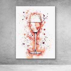 a wine glass with red paint splattered on it is displayed against a concrete wall