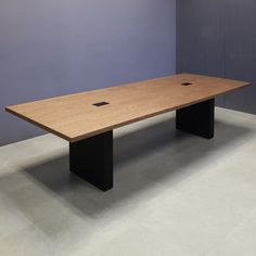 a wooden table sitting in front of a blue wall with two square holes on it