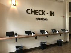 the check in stations are lined up on the wall