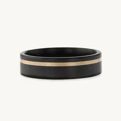 a black and gold striped ring on a white background