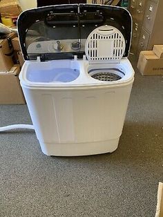 a white washing machine sitting on top of a floor