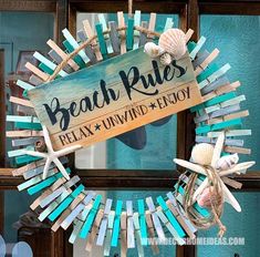 a wreath made out of popsicle sticks with the words beach rules displayed on it