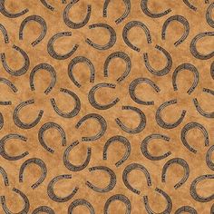 a brown background with black and white horseshoes on the bottom, in an oval pattern