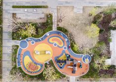 an aerial view of a colorful playground in the park